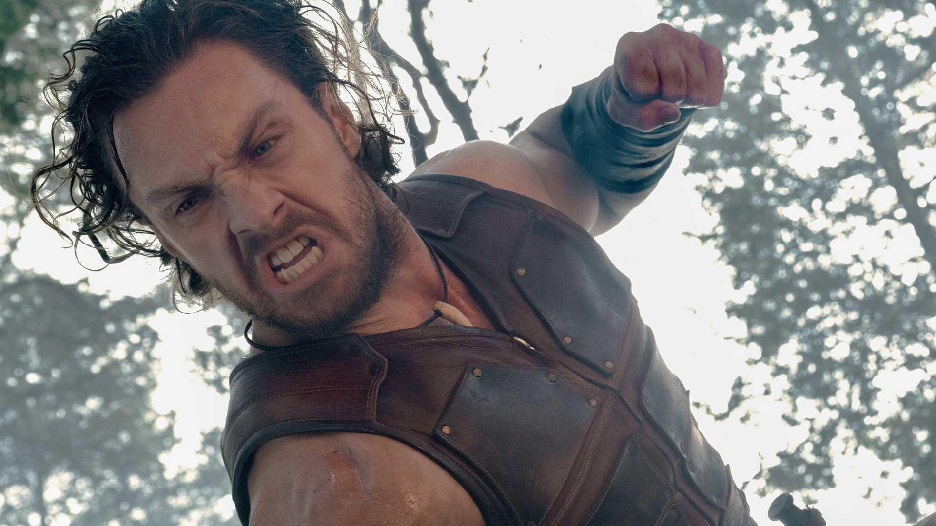 Kraven the Hunter (Aaron Taylor-Johnson) punches someone off-screen